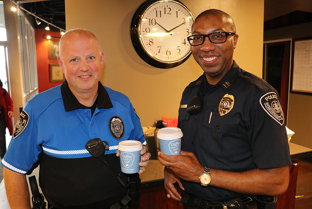 Police Officers In Living Room Drinking Coffee